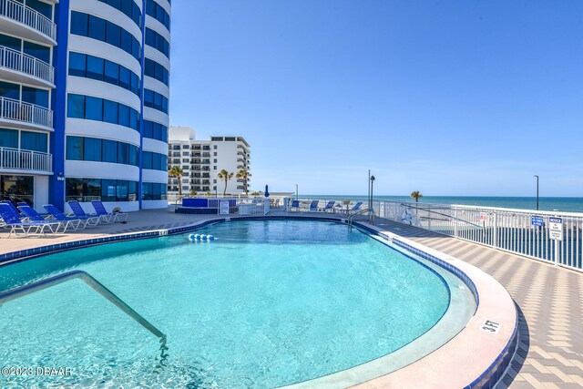 view of pool with a water view