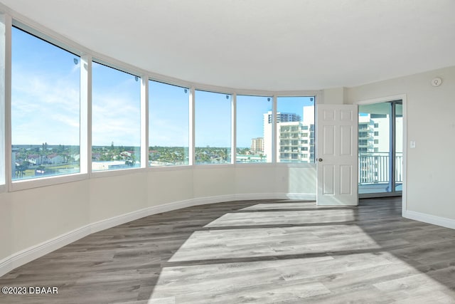 unfurnished sunroom featuring a water view and a healthy amount of sunlight