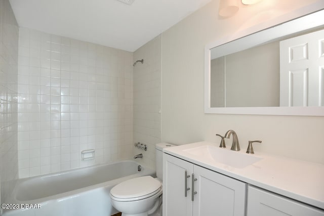 full bathroom featuring vanity, toilet, and tiled shower / bath