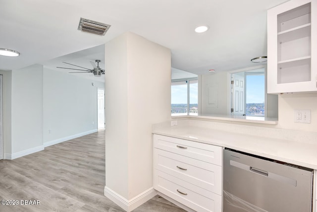 kitchen with white cabinets, light hardwood / wood-style flooring, stainless steel dishwasher, and ceiling fan