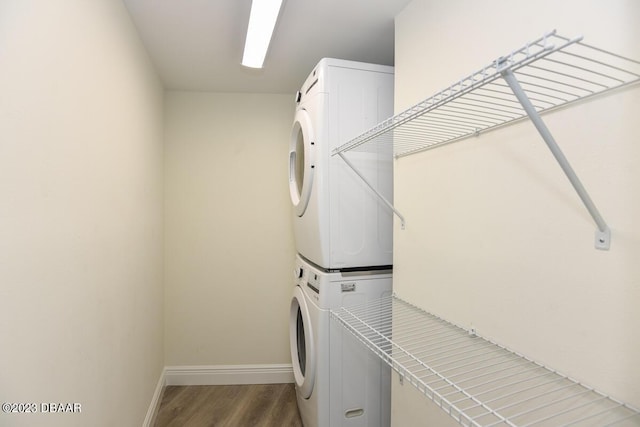 2625 S Atlantic Ave Unit 7Nw, Daytona Beach Shores, FL 32118 - laundry room with stacked washer / dryer, wood finished floors, and baseboards