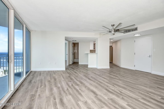 2625 S Atlantic Ave Unit 7Nw, Daytona Beach Shores, FL 32118 - unfurnished living room with light wood-style floors, ceiling fan, and baseboards