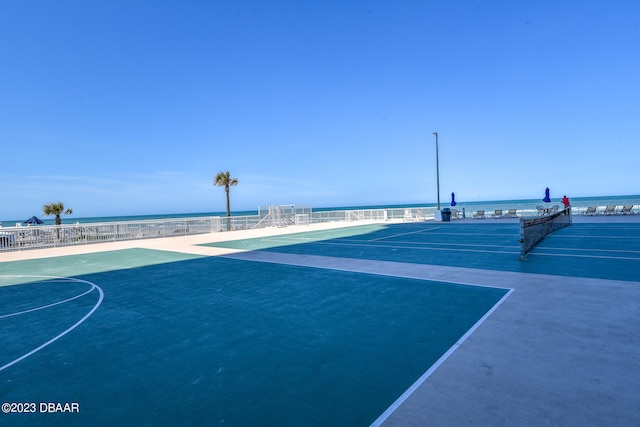 view of home's community with a water view and basketball court