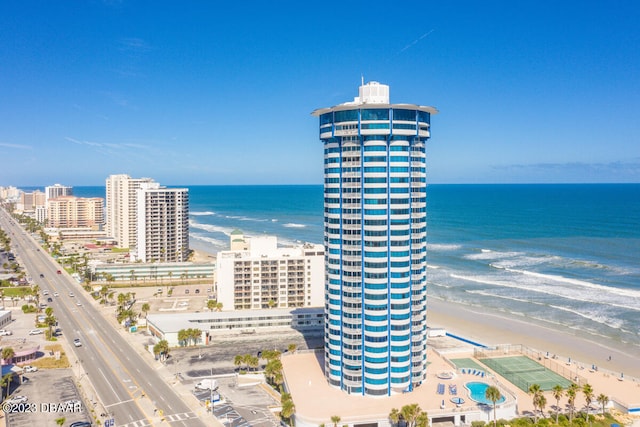 drone / aerial view with a beach view and a water view