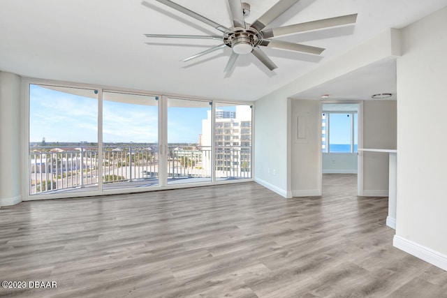 empty room with light hardwood / wood-style floors and ceiling fan