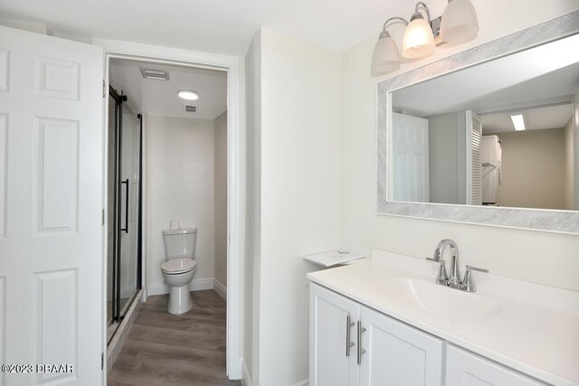 bathroom featuring hardwood / wood-style flooring, vanity, and toilet