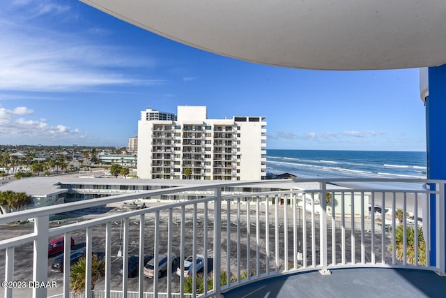 balcony featuring a water view and a view of the beach