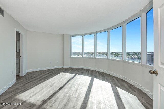 unfurnished sunroom featuring a water view