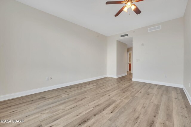 231 Riverside Dr Unit 2601-1, Daytona Beach, FL 32117 - spare room featuring ceiling fan, light wood-style floors, and baseboards