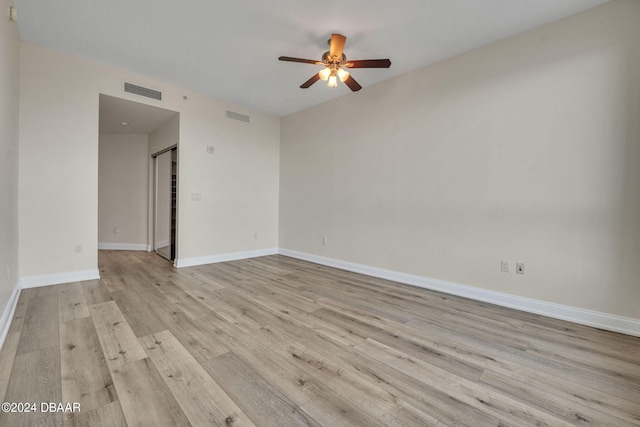 spare room featuring light hardwood / wood-style floors and ceiling fan