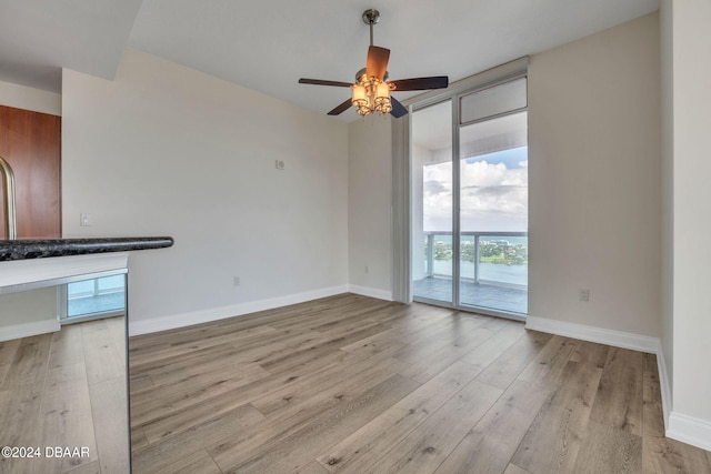 unfurnished living room featuring light hardwood / wood-style floors and ceiling fan