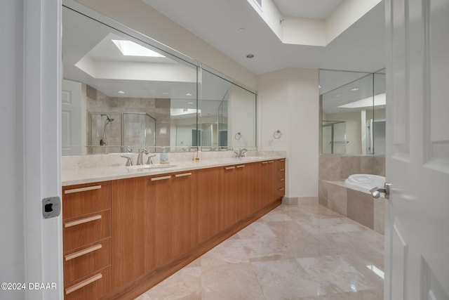 bathroom featuring vanity, plus walk in shower, and a skylight