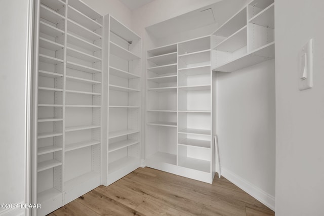 spacious closet featuring hardwood / wood-style flooring