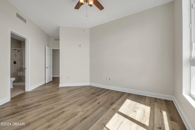 231 Riverside Dr Unit 2601-1, Daytona Beach, FL 32117 - unfurnished bedroom featuring wood finished floors, ensuite bath, baseboards, and ceiling fan