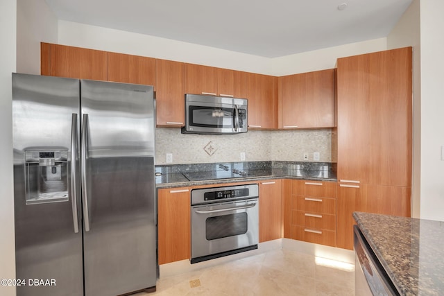 231 Riverside Dr Unit 2601-1, Daytona Beach, FL 32117 - kitchen featuring stainless steel appliances, brown cabinets, and decorative backsplash