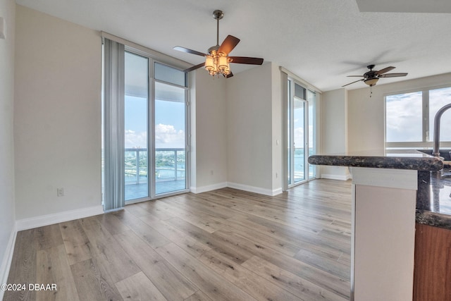 231 Riverside Dr Unit 2601-1, Daytona Beach, FL 32117 - unfurnished living room with ceiling fan, healthy amount of natural light, and light wood-style flooring