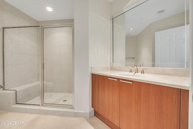 bathroom featuring vanity, tile patterned floors, and a shower with door