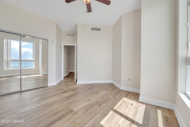 231 Riverside Dr Unit 2601-1, Daytona Beach, FL 32117 - unfurnished bedroom with light wood-style floors, baseboards, a ceiling fan, and a closet