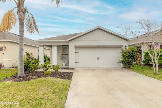 ranch-style home with a garage and a front lawn