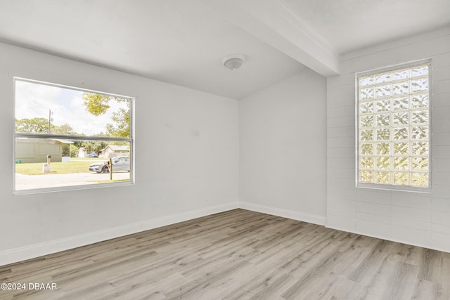 1703 Hill St, Edgewater, FL 32132 - unfurnished room featuring beamed ceiling, a healthy amount of sunlight, and light wood-type flooring