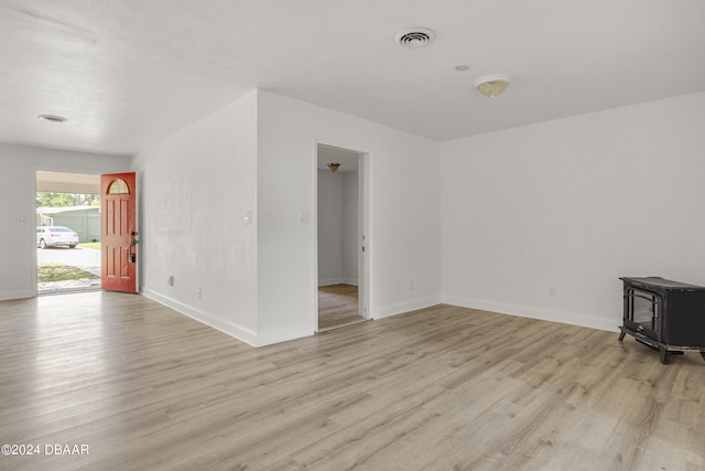 1703 Hill St, Edgewater, FL 32132 - unfurnished room with light wood-type flooring and a wood stove