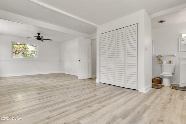 1703 Hill St, Edgewater, FL 32132 - unfurnished bedroom featuring light wood-type flooring, ceiling fan, and connected bathroom