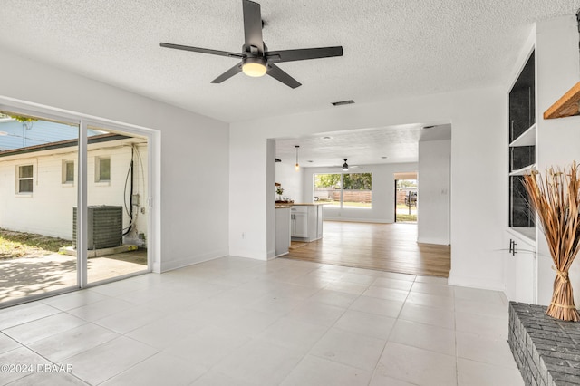 1703 Hill St, Edgewater, FL 32132 - unfurnished living room with light wood-type flooring, a textured ceiling, and ceiling fan