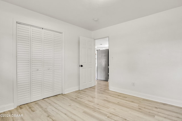 1703 Hill St, Edgewater, FL 32132 - unfurnished bedroom featuring light hardwood / wood-style flooring and a closet