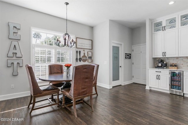 dining area featuring dark hardwood / wood-style flooring, wine cooler, and a chandelier