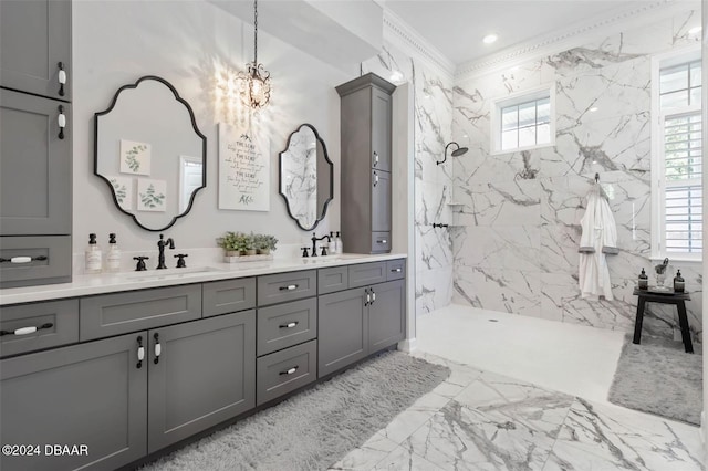 bathroom with vanity, a tile shower, and crown molding