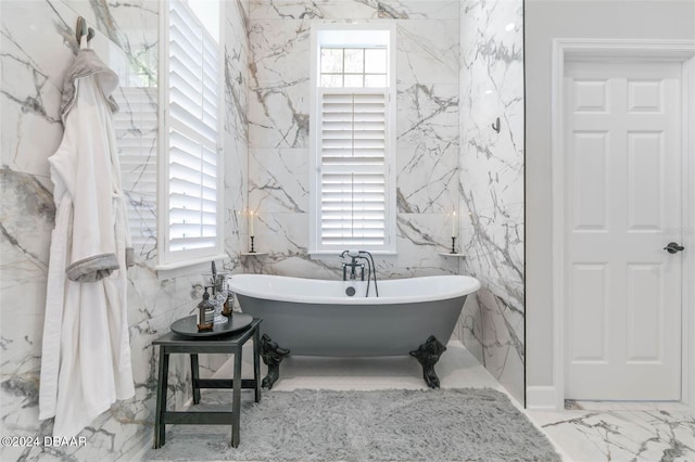 bathroom with plenty of natural light and a washtub