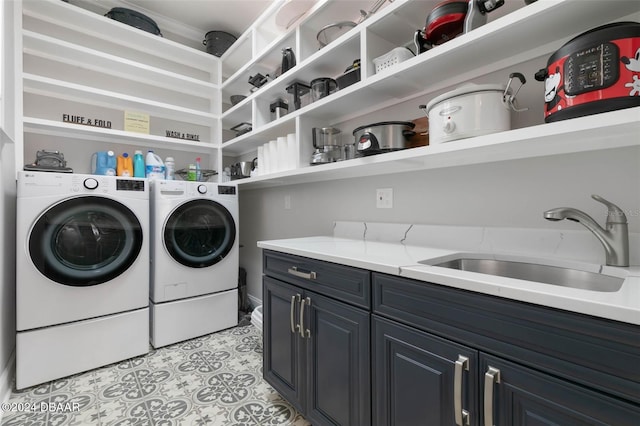 laundry area featuring cabinets, separate washer and dryer, sink, and light tile patterned floors