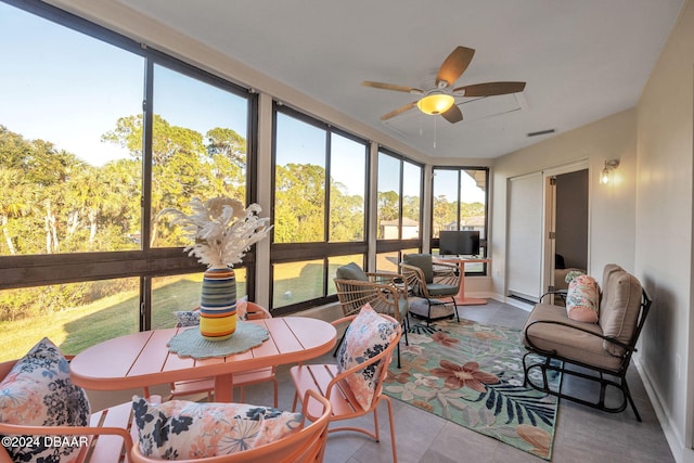 sunroom / solarium featuring ceiling fan