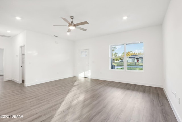 spare room with hardwood / wood-style floors and ceiling fan