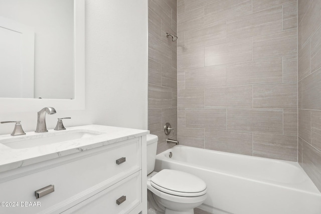 full bathroom featuring vanity, tiled shower / bath combo, and toilet