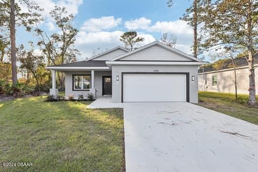 single story home featuring a front lawn and a garage