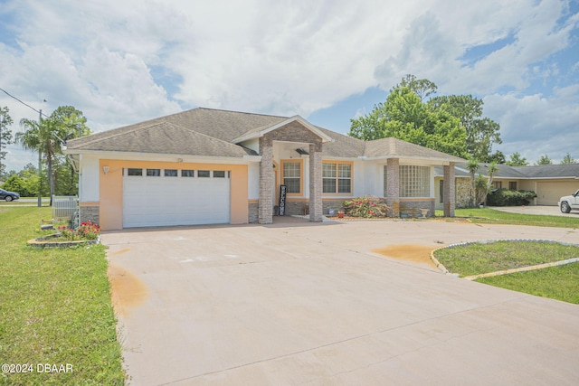 view of front facade with a garage and a front lawn