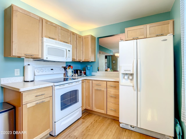 kitchen with light brown cabinets, light hardwood / wood-style flooring, and white appliances