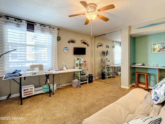 interior space featuring light colored carpet and ceiling fan