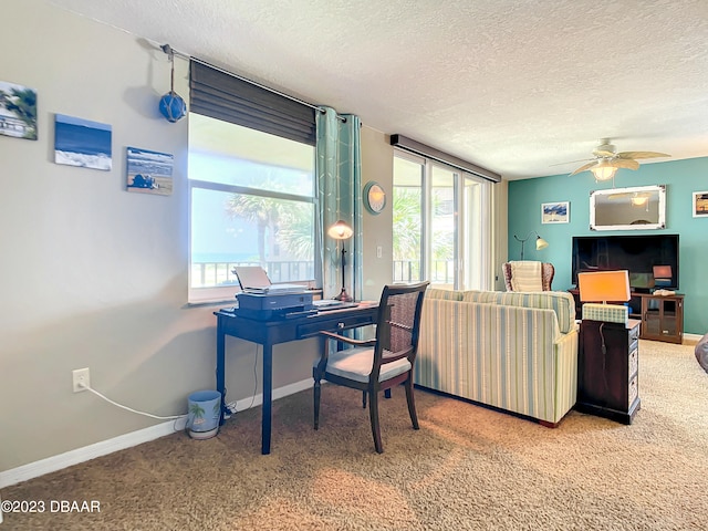 living room featuring carpet floors, a textured ceiling, and ceiling fan