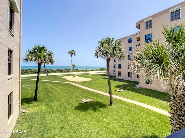 view of property's community featuring a water view and a lawn