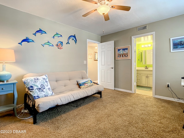 interior space with carpet, sink, and ceiling fan