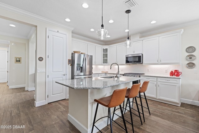 kitchen featuring white cabinetry, appliances with stainless steel finishes, sink, and a center island with sink