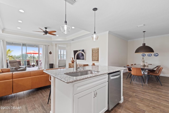 kitchen with sink, decorative light fixtures, dishwasher, light stone countertops, and white cabinets