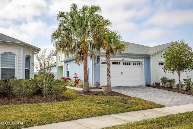 view of front of house featuring a garage and a front lawn