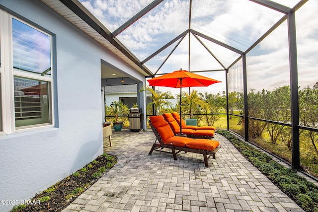 view of patio / terrace featuring a lanai and grilling area