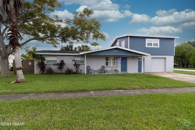 view of front of property with a garage and a front yard