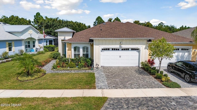 view of front of home featuring a garage and a front yard