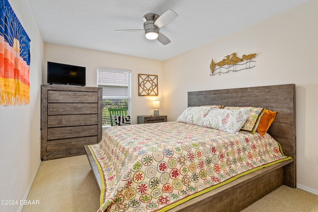 carpeted bedroom with a textured ceiling and ceiling fan