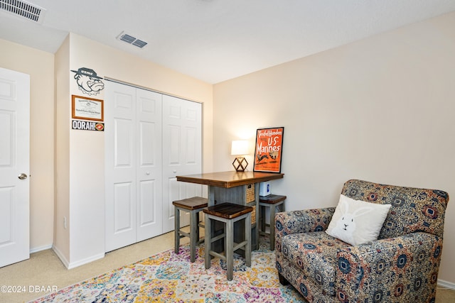 sitting room featuring light colored carpet